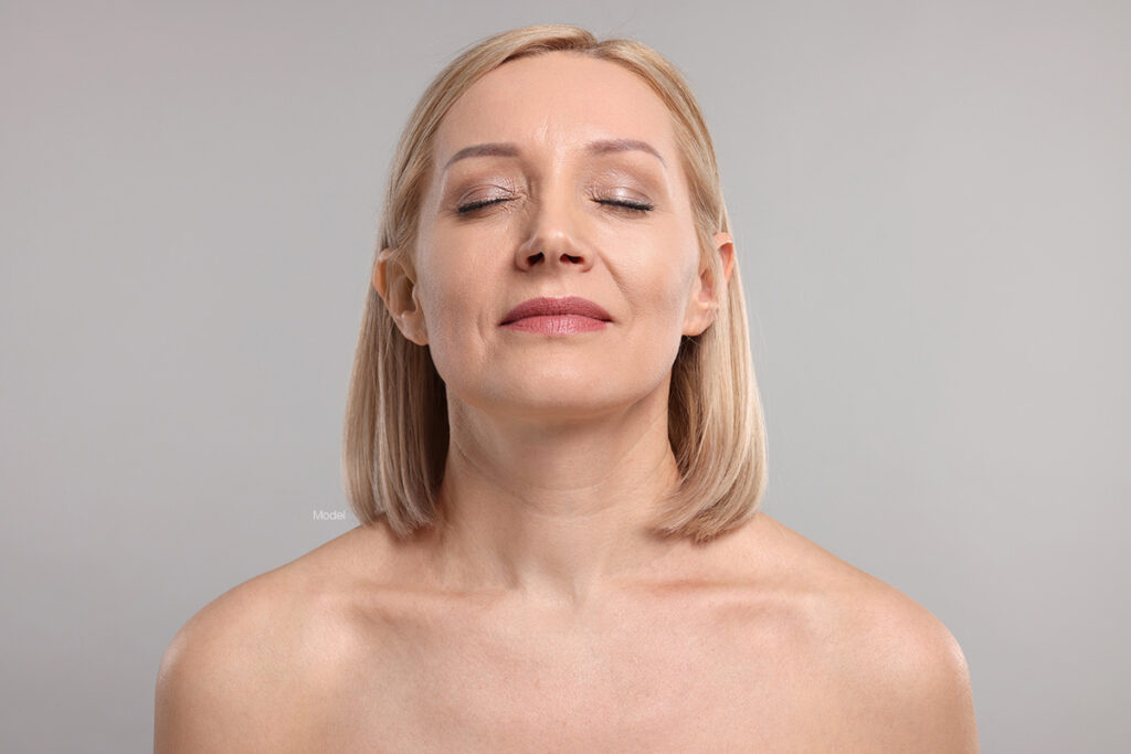 Mature woman with her head raised and eyes closed